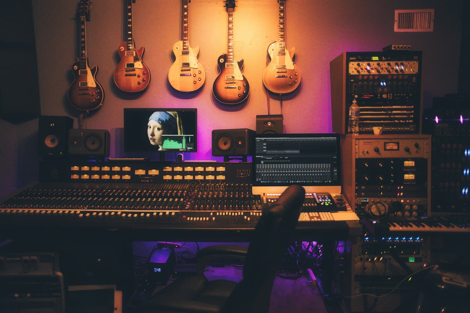 Studio monitors and a mixing desk in a treated room